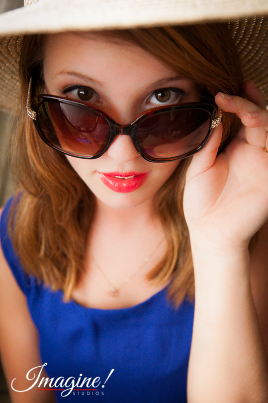 Bethany peers over her sunglasses during her senior model outdoor photo session at Highland Lake Inn in Flat Rock, NC