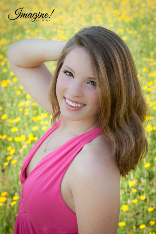 Bethany smiles during her senior model outdoor photo session in a wildflower field in Greer, SC
