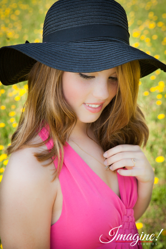 Bethany relaxes during her senior model outdoor photo session in a wildflower field in Greer, SC