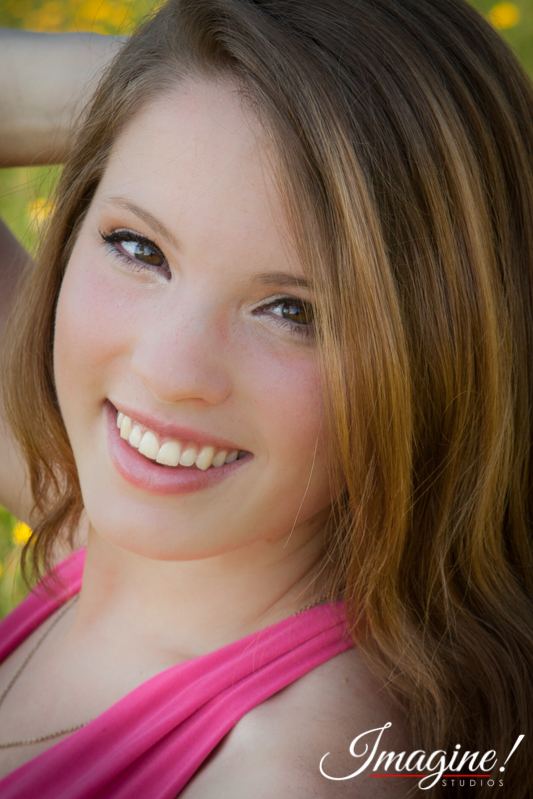 Bethany smiles for a closeup during her senior model outdoor photo session