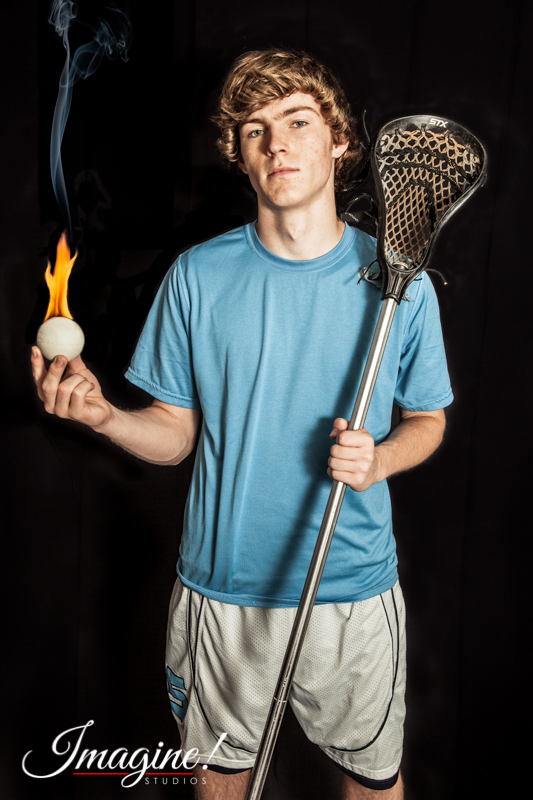 Matthew holds a burning lacrosse ball