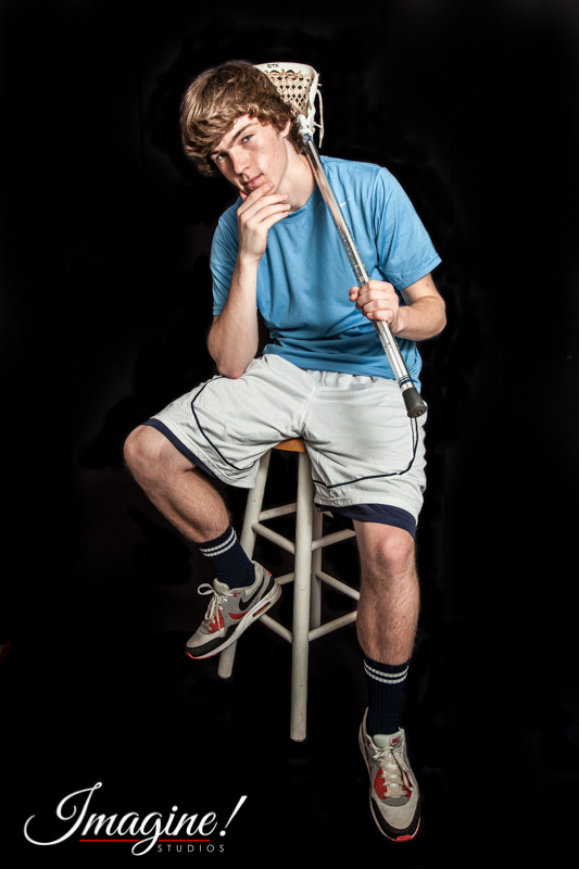 Matthew makes a cool pose with his lacrosse stick during his studio shoot