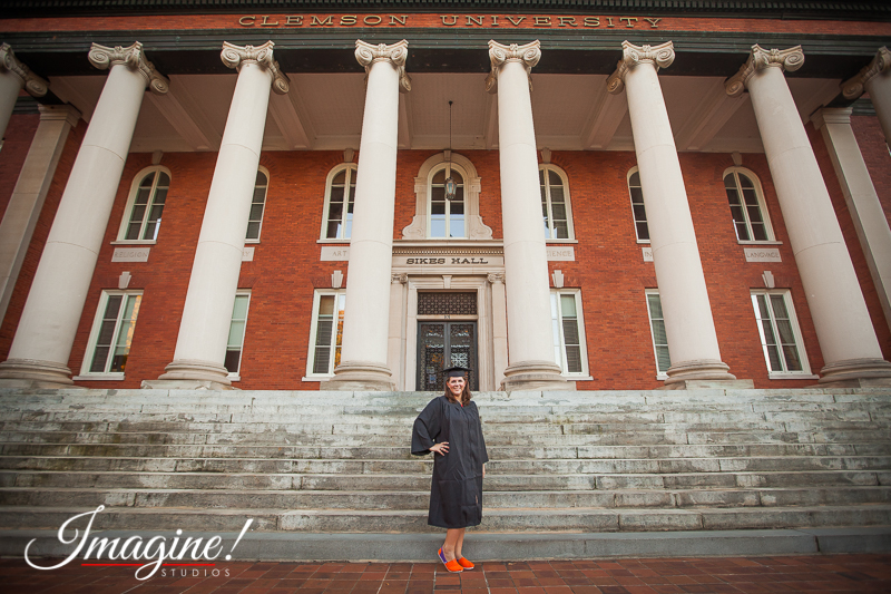 Amethyst poses in her cap and gown outside Sikes Hall at Clemson University