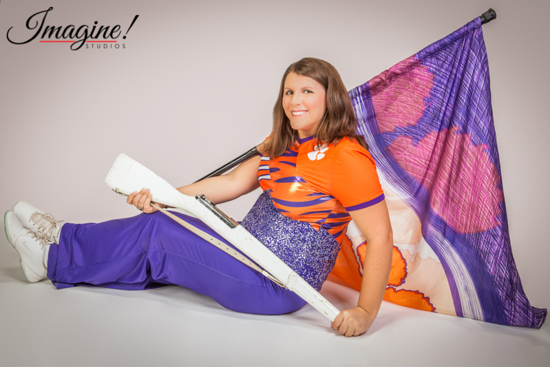 Amethyst in her Clemson color guard uniform with her flag and rifle