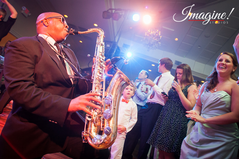 The reception band saxophone player entertains the wedding guests