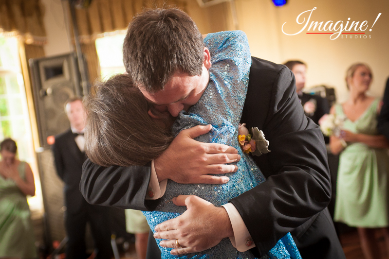 John embraces his mother at the conclusion of the groom/mother dance