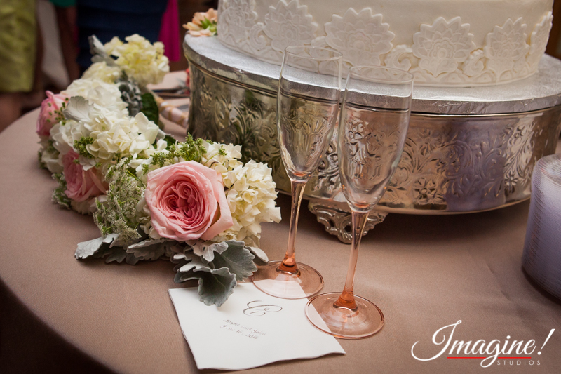 Champagne glasses and wedding cake table setting