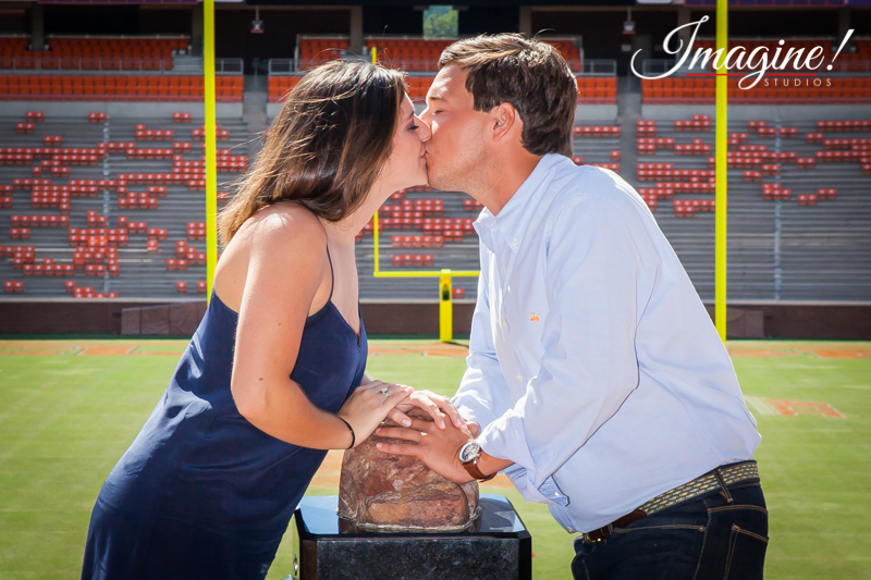 Brad and Hannah share a kiss over Howard's Rock at the top of the hill inside Clemson Memorial Stadium