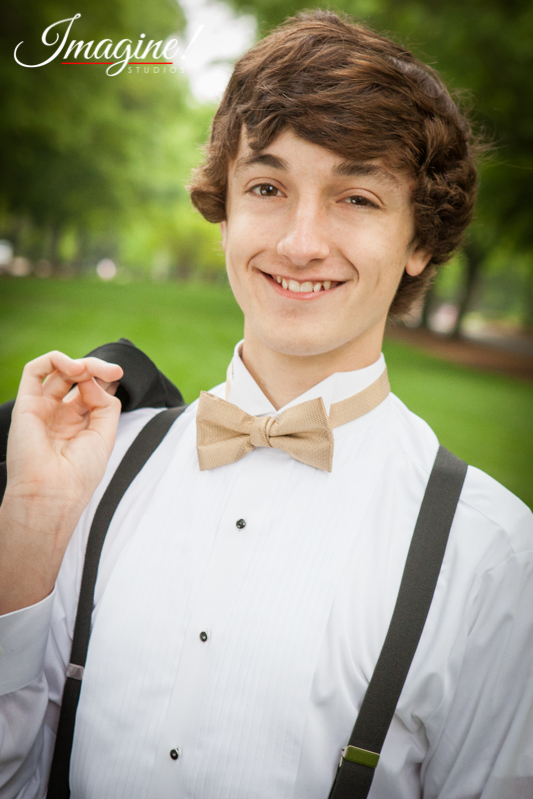 Jacob smiles for an individual closeup photo on the grassy mall at Furman University